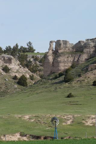 A windmill against the bluffs in Banner County